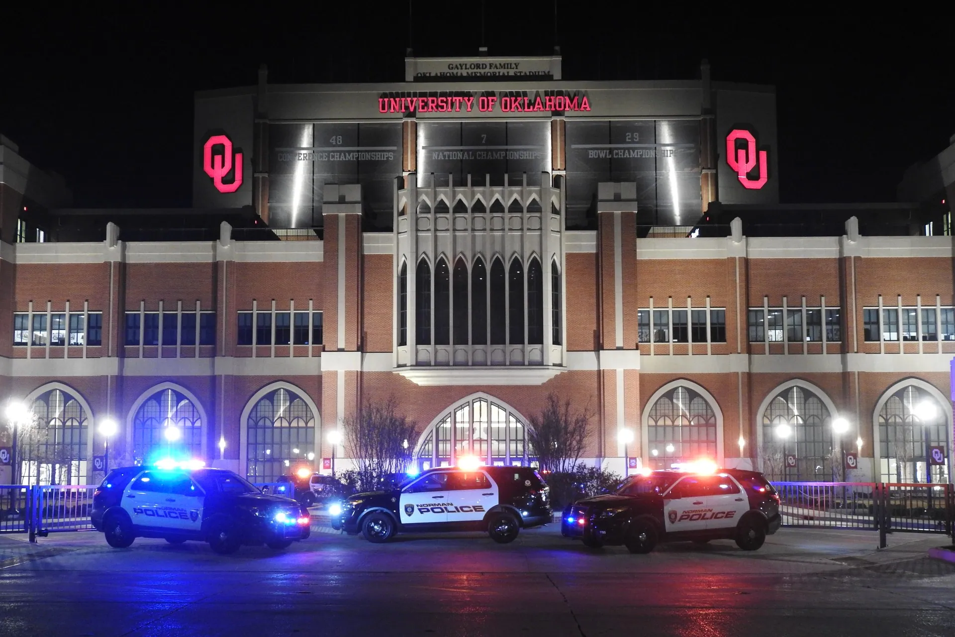 Norman PD vehicles with lights flashing outside the University of Oklahoma