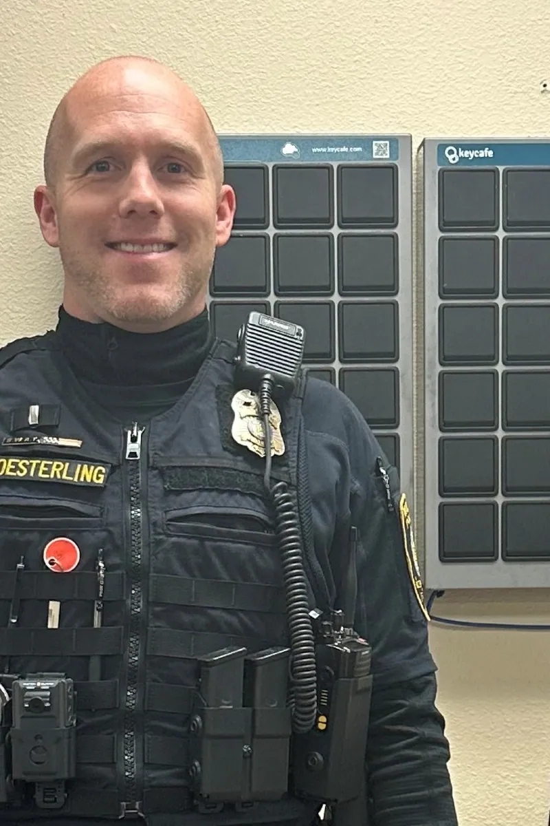 Lieutenant Deny Oesterling standing in front of the department's SmartBoxes