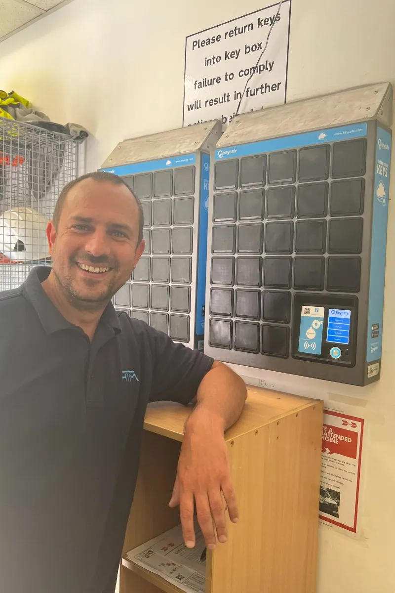 Operations Manager Mikee Booth smiling beside Highway Traffic Management's SmartBoxes