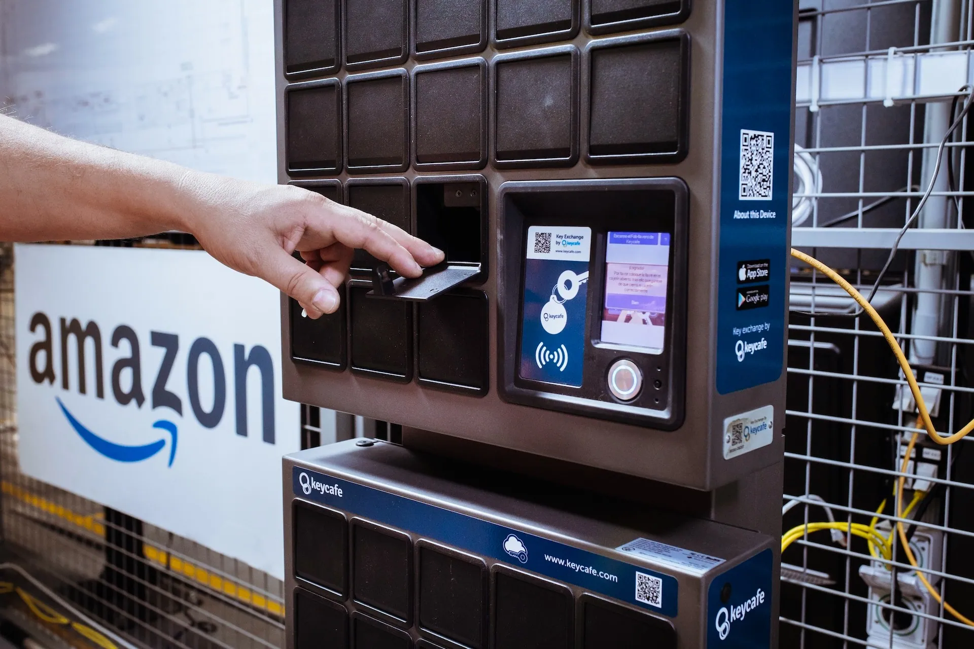 Amazon employee reaching towards an open SmartBox bin
