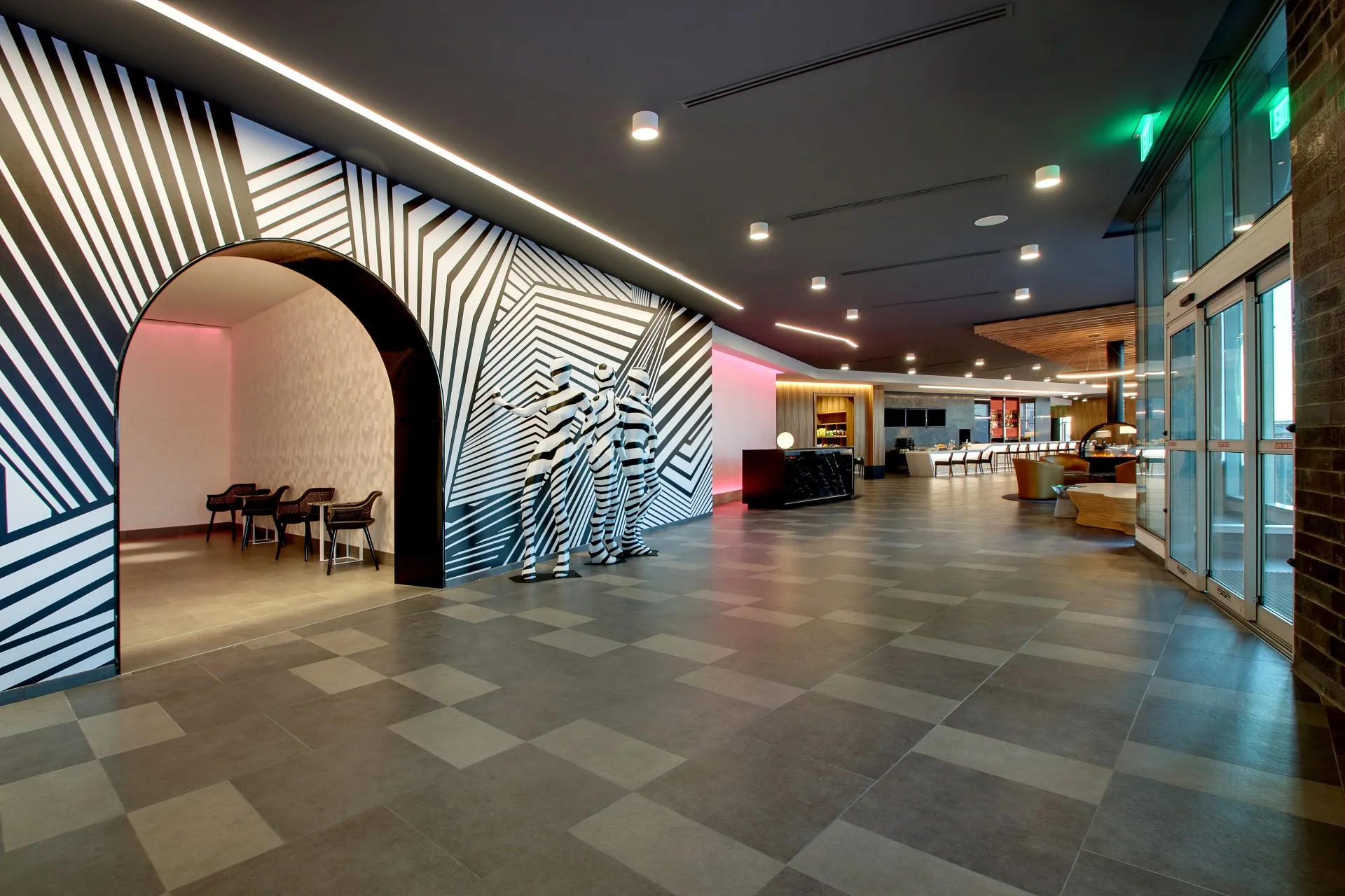 The lobby of The Rose Hotel Chicago with neon lighting and modern art
